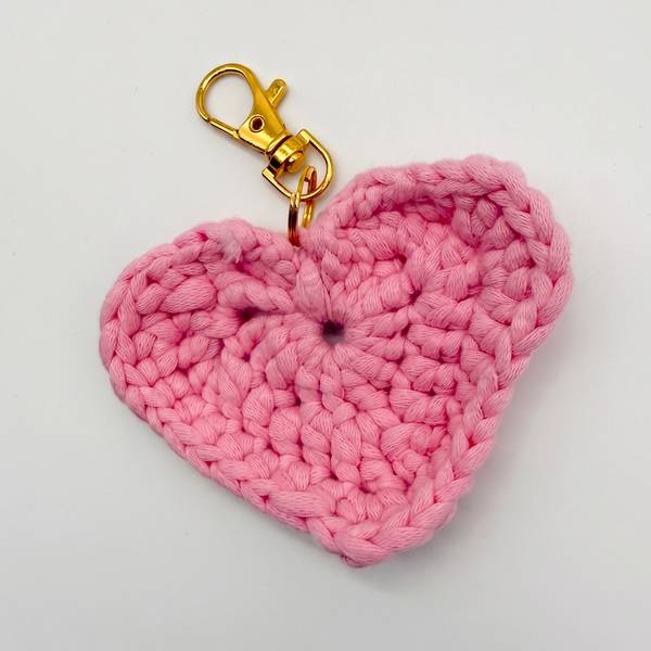 Crocheted heart bag charm with a gold clasp